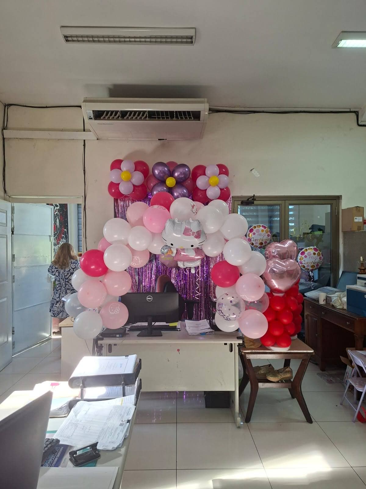 Decoración con arcos de globos rosas y blancos con temática de Hello Kitty para cumpleaños infantil