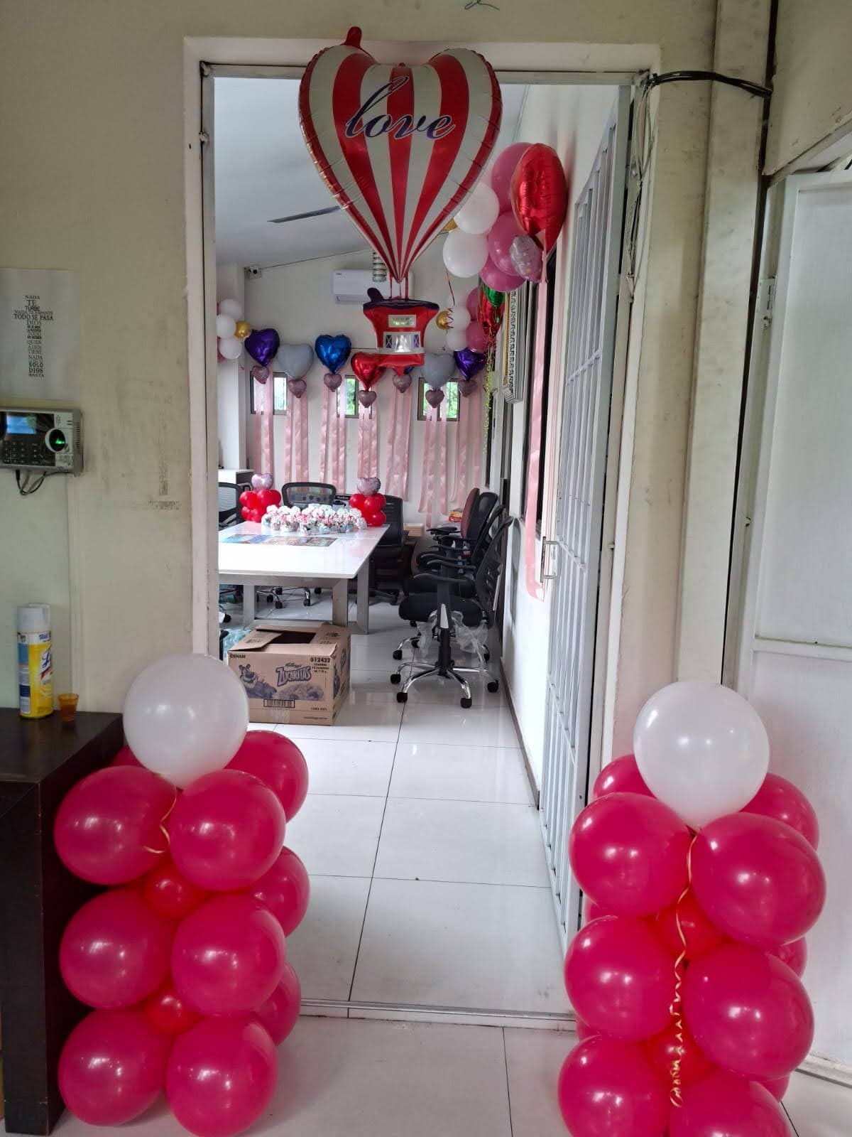 Entrada decorada con corazón gigante y globos metálicos en colores románticos
